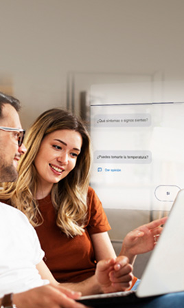 Two people sitting reviewing information on a computer.